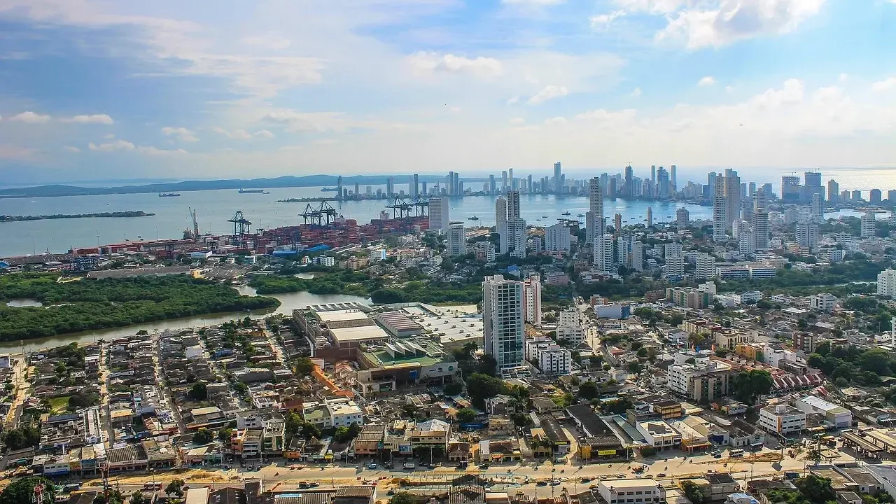 . Aerial view of Colombia City's skyline, showcasing modern skyscrapers against a clear blue sky.
