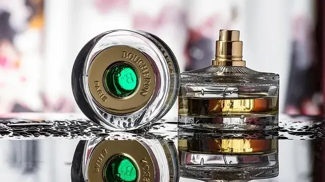 Three distinct perfume bottles displayed on a sleek black surface, showcasing various shapes and designs.