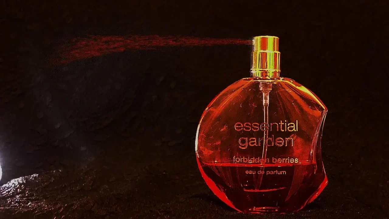 A bottle of perfume elegantly placed on a wooden table, reflecting soft light.