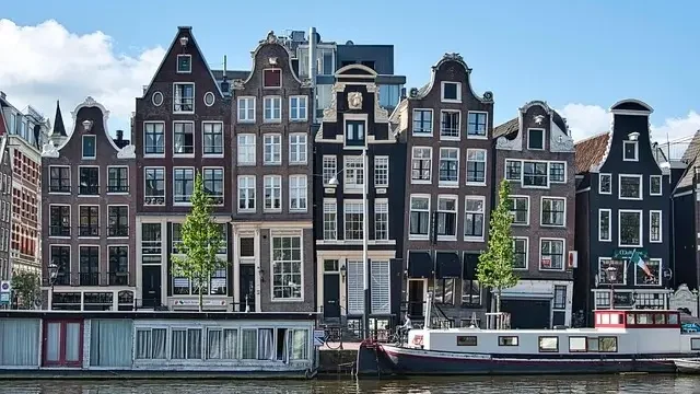 A scenic view of Amsterdam's iconic canals and historic architecture, showcasing the city's unique charm and beauty