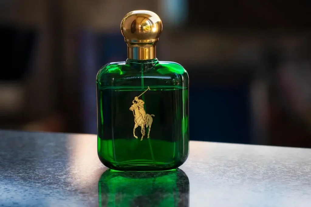 A green bottle featuring a gold horse design on its surface