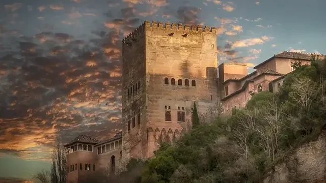 The Alhambra, a historic palace and fortress in Granada, Spain, showcasing intricate Islamic architecture and lush gardens