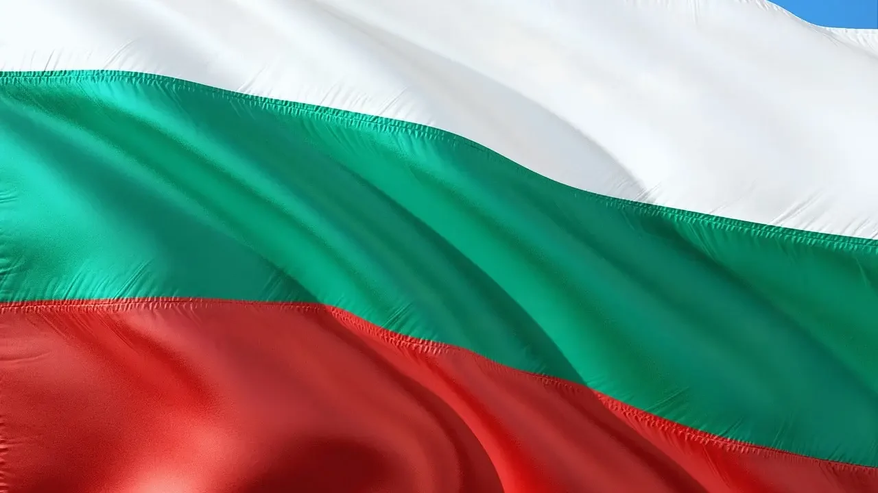 The flag of Bulgaria featuring three horizontal stripes: white on top, green in the middle, and red at the bottom
