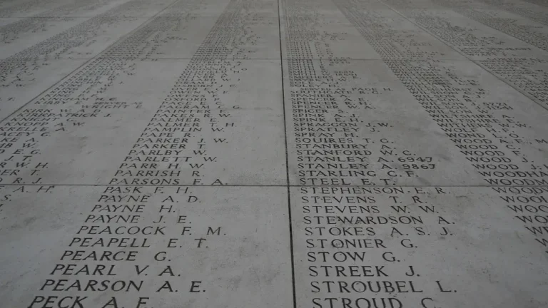 A memorial wall displaying the names of men who lost their lives in the war, honoring their sacrifice and memory