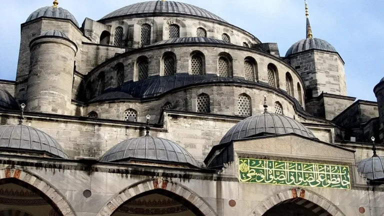 The Blue Mosque in Istanbul, Turkey, showcasing its iconic domes and minarets against a clear blue sky