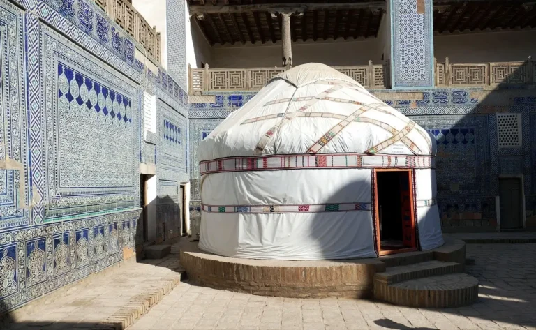 A white tent featuring a blue and white patterned design, set against a neutral background