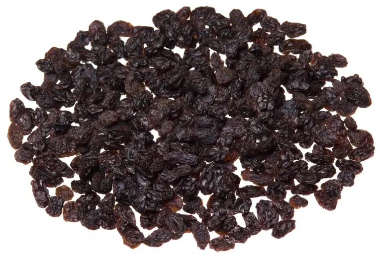 A pile of dark brown raisins on a clean white background, showcasing their wrinkled texture and natural sweetness