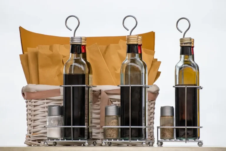 Three bottles of wine displayed together, showcasing different labels and colors of the Vinegar inside
