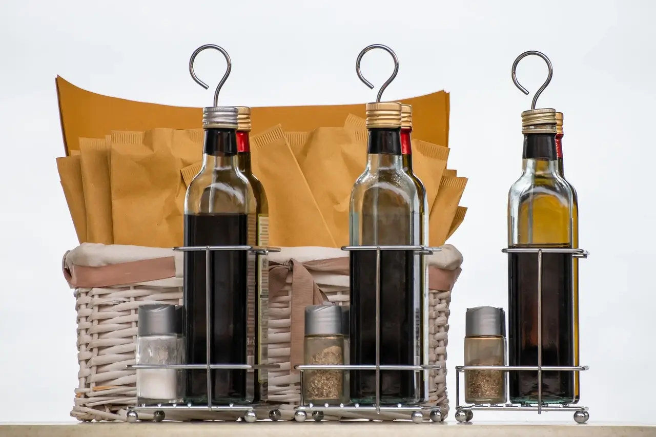 Three bottles of wine displayed together, showcasing different labels and colors of the Vinegar inside