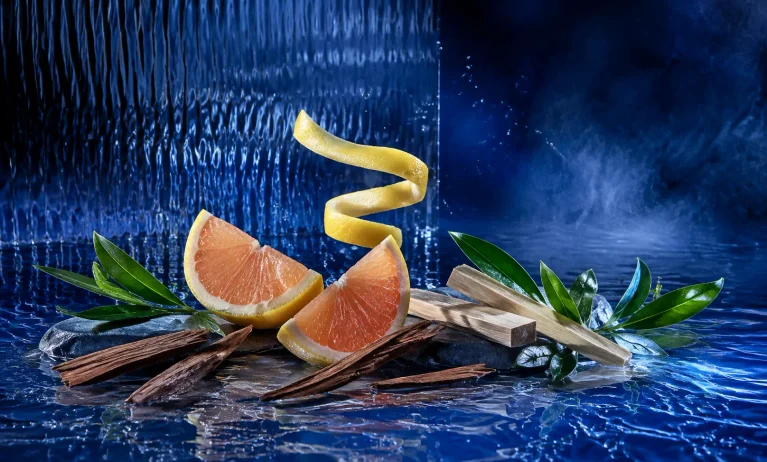Grapefruit, aromatic green leaves, cedar, and sandalwood on a cobalt-blue water surface representing Bleu de Chanel Eau de Toilette.